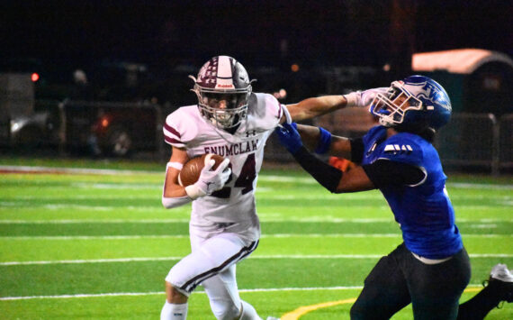 Enumclaw senior RB Louis Chevalier stiff arms an Eagle defender. Ben Ray / The Mirror