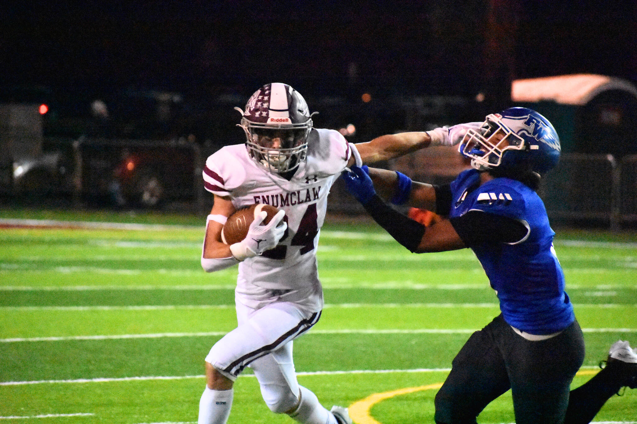 Enumclaw senior RB Louis Chevalier stiff arms an Eagle defender. Ben Ray / The Mirror