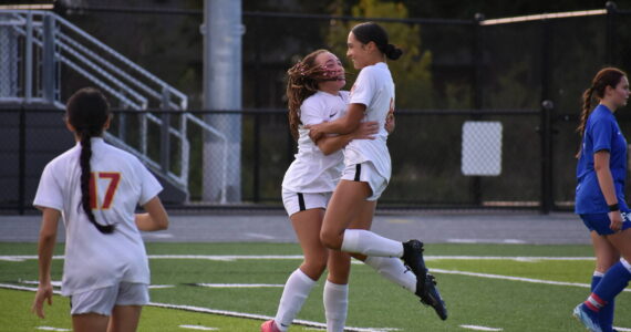 Jazmyne DuBose and Athena Amor Katsaros celebrate a goal against Federal Way. Ben Ray / The Mirror