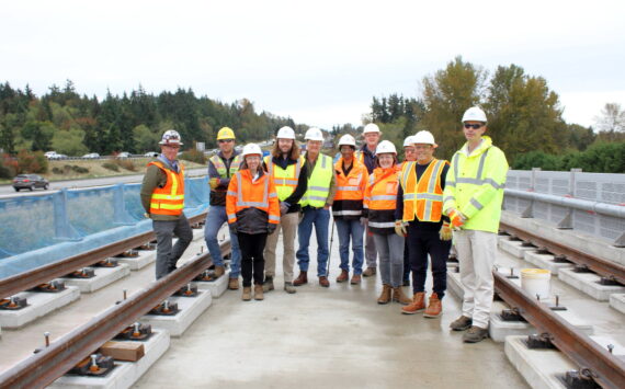 Mayor Ferrell and Sound Transit staff stand under Structure C which includes the longest bridge built by Sound Transit. The bridge was completed recently and they are now moving to the next phase that focuses on the rail itself atop the bridge. Photo by Keelin Everly-Lang / the Mirror