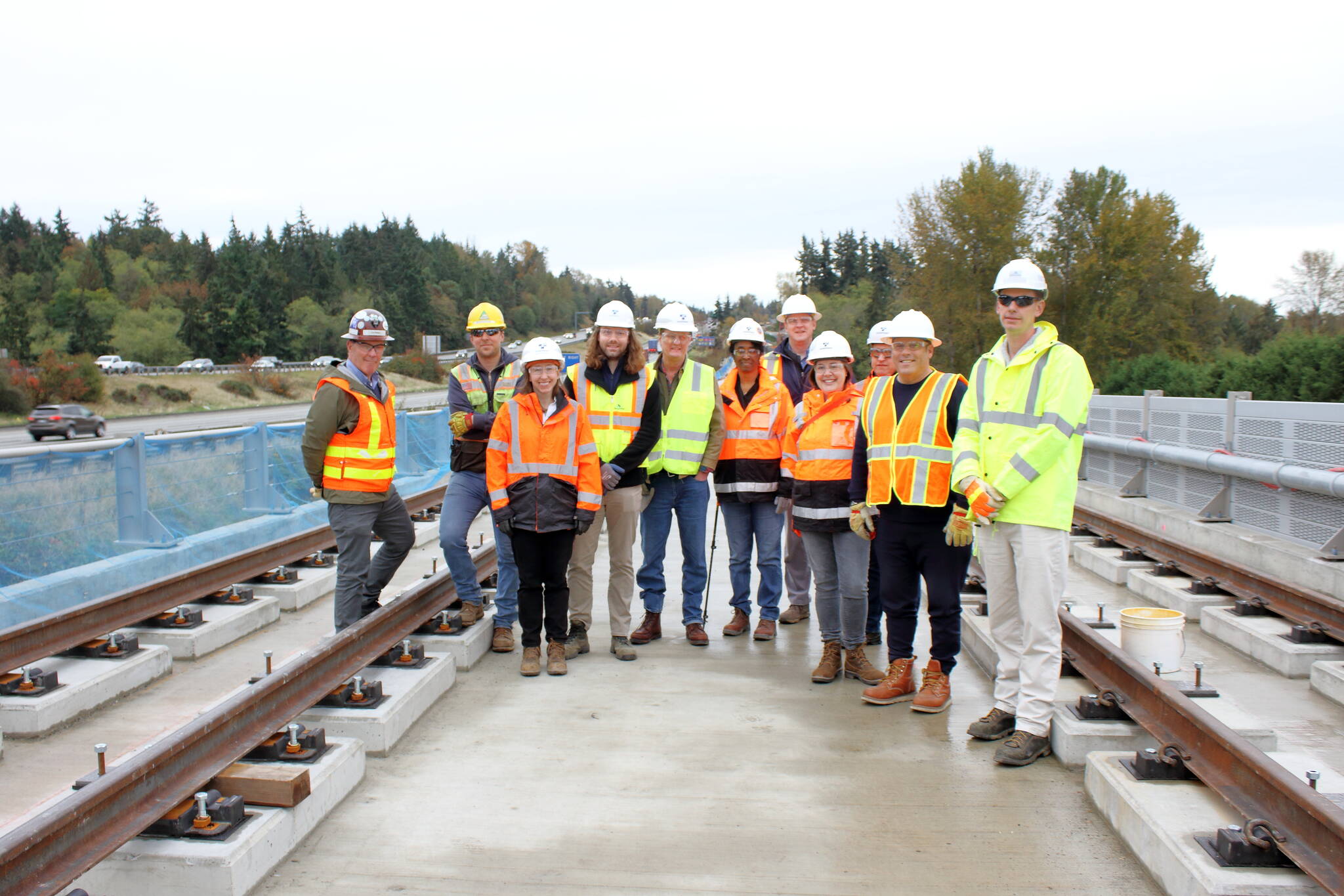 Mayor Ferrell and Sound Transit staff stand under Structure C which includes the longest bridge built by Sound Transit. The bridge was completed recently and they are now moving to the next phase that focuses on the rail itself atop the bridge. Photo by Keelin Everly-Lang / the Mirror