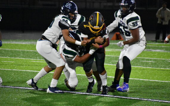 The Todd Beamer Titan defense swarms the Raiders quarterback. Ben Ray / The Mirror