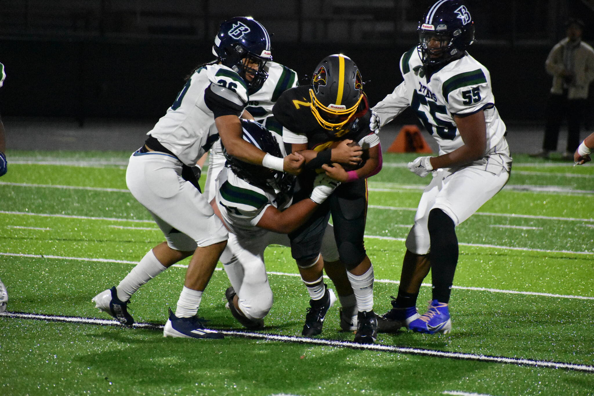 The Todd Beamer Titan defense swarms the Raiders quarterback. Ben Ray / The Mirror