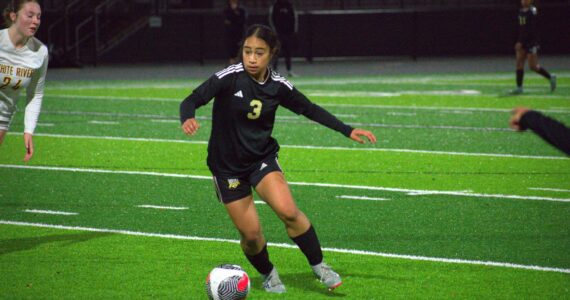 Decatur sophomore Kaihea Tuifua dribbles the ball between White River defenders. Ben Ray / The Mirror