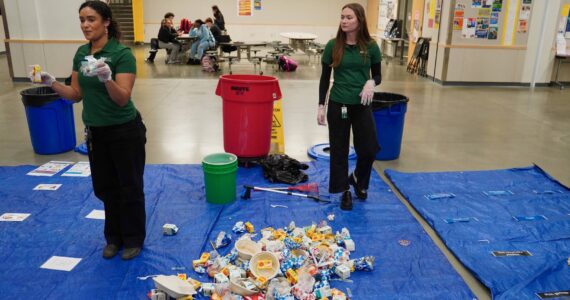 Rhianne Janovich and Grace Fletcher from WM explaining to the students how they would sort out the trash. Photo by Joshua Solorzano/The Mirror