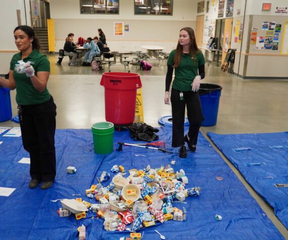 Rhianne Janovich and Grace Fletcher from WM explaining to the students how they would sort out the trash. Photo by Joshua Solorzano/The Mirror