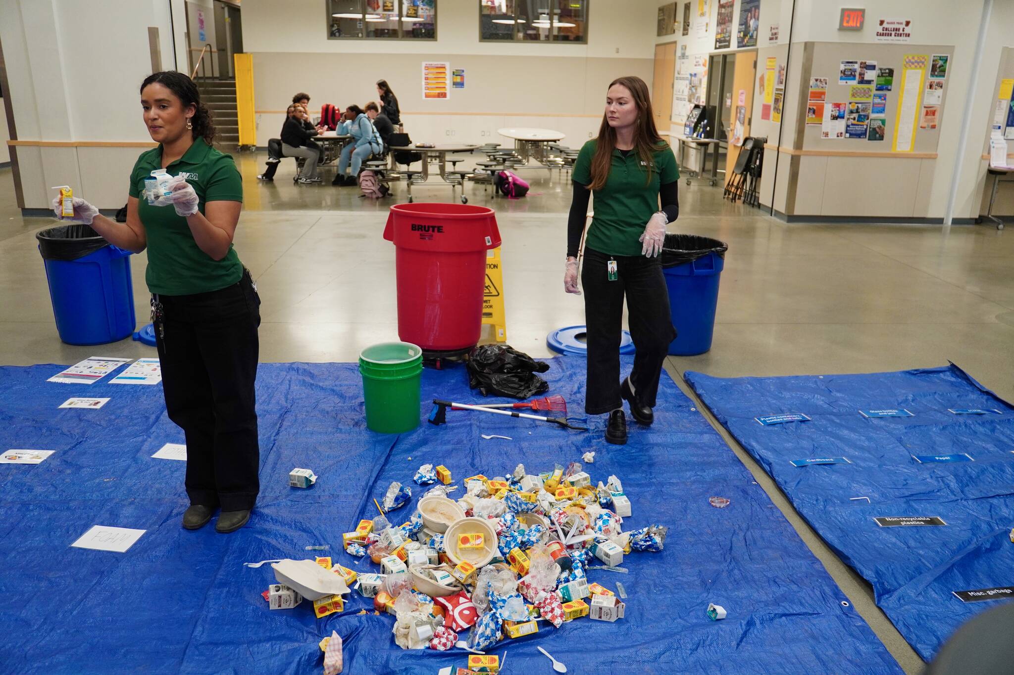 Rhianne Janovich and Grace Fletcher from WM explaining to the students how they would sort out the trash. Photo by Joshua Solorzano/The Mirror