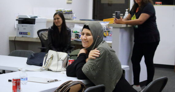 Nooriya Assi Sulaman is a graduate of the Mujer al Volante driving instruction class in Federal Way. Behind her are two of the Mujer al Volante staff. Photo by Keelin Everly-Lang / the Mirror.