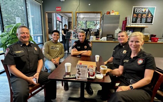 South King Fire Chief Dave Van Valkenburg, left, sits with a guest, District Chief Layne Winter, Deputy Chief Shane Smith and Deputy Chief Lisa Defenbaugh at Poverty Bay Cafe. Photo by Joshua Solorzano/The Mirror