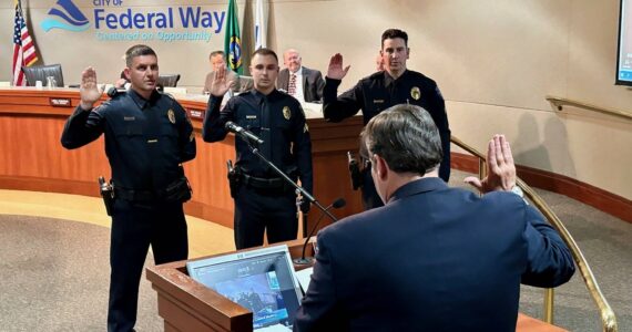 Mayor Jim Ferrell swearing in new officers at a city council meeting. Courtesy photo.