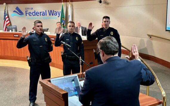 Mayor Jim Ferrell swearing in new officers at a city council meeting. Courtesy photo.