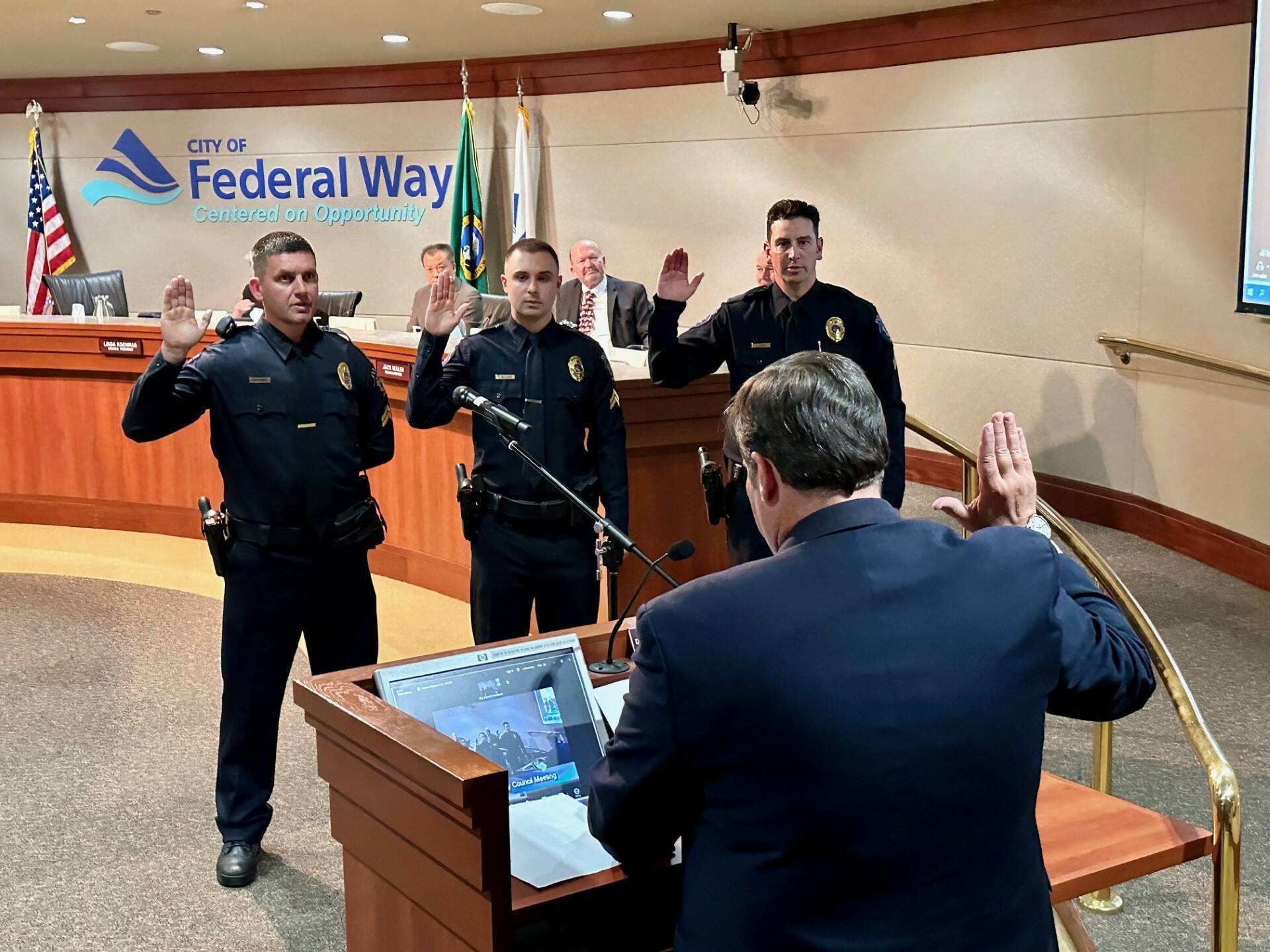 Mayor Jim Ferrell swearing in new officers at a city council meeting. Courtesy photo.