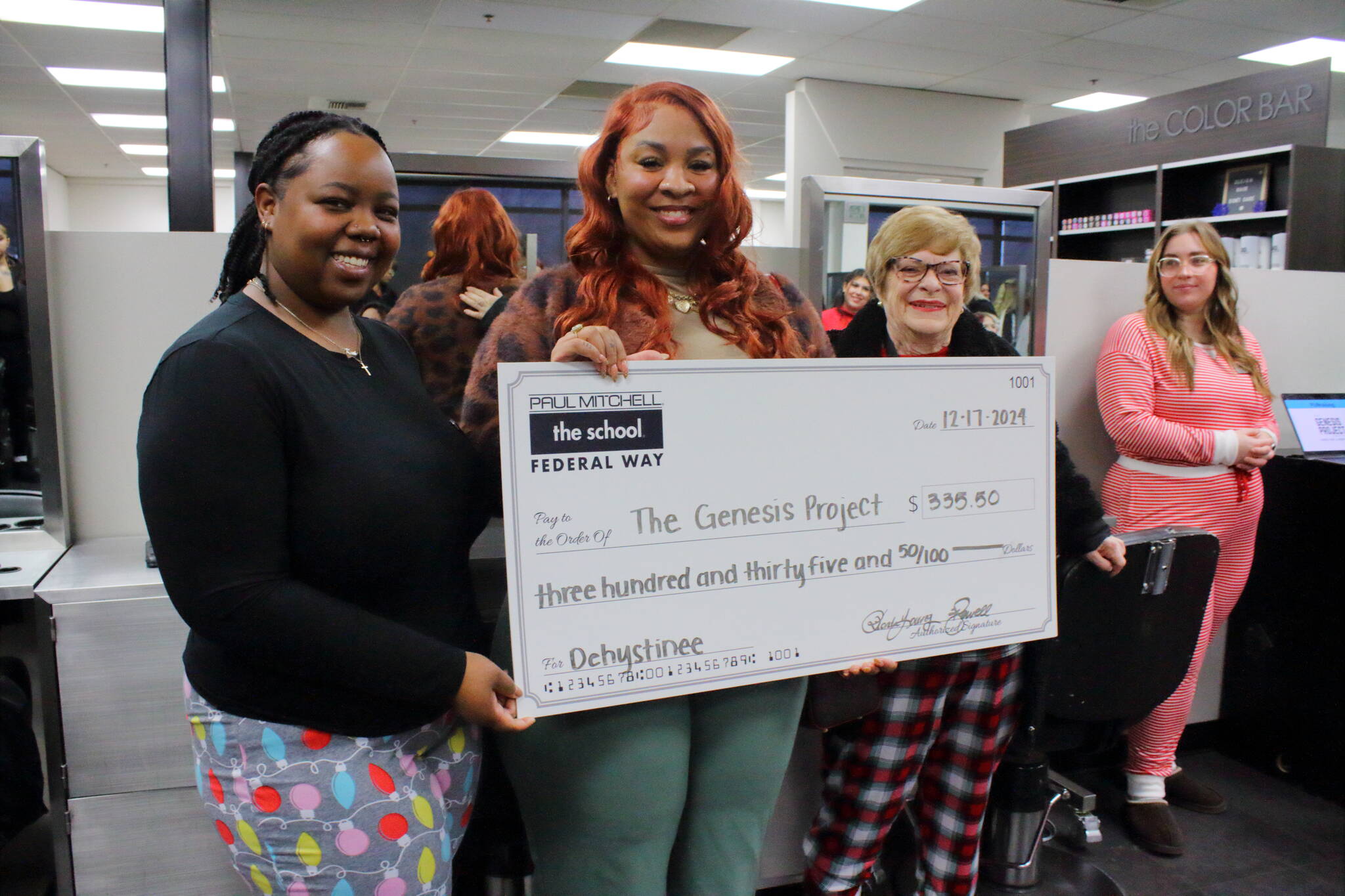 Learning Leaders Ka’Shayla Jewell and Rhonda Young present the check to Center Director and Case Manager for the Genesis Project Dehystinee Davis. Photo by Keelin Everly-Lang / the Mirror