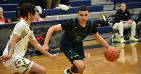 Titan senior Jaylin Wells dribbles against Kentridge. Ben Ray / The Mirror