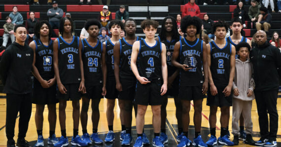 The Federal Way Eagles boys basketball team pose with their George Houston Capital City Classic championship trophy on Sunday. (Klas Stolpe / Juneau Empire)