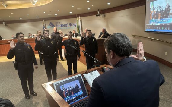 Mayor Jim Ferrell swears in officers of the Federal Way Police Department at the city council meeting on Jan. 7. Photo by Ben Miller.