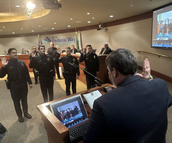 Mayor Jim Ferrell swears in officers of the Federal Way Police Department at the city council meeting on Jan. 7. Photo by Ben Miller.