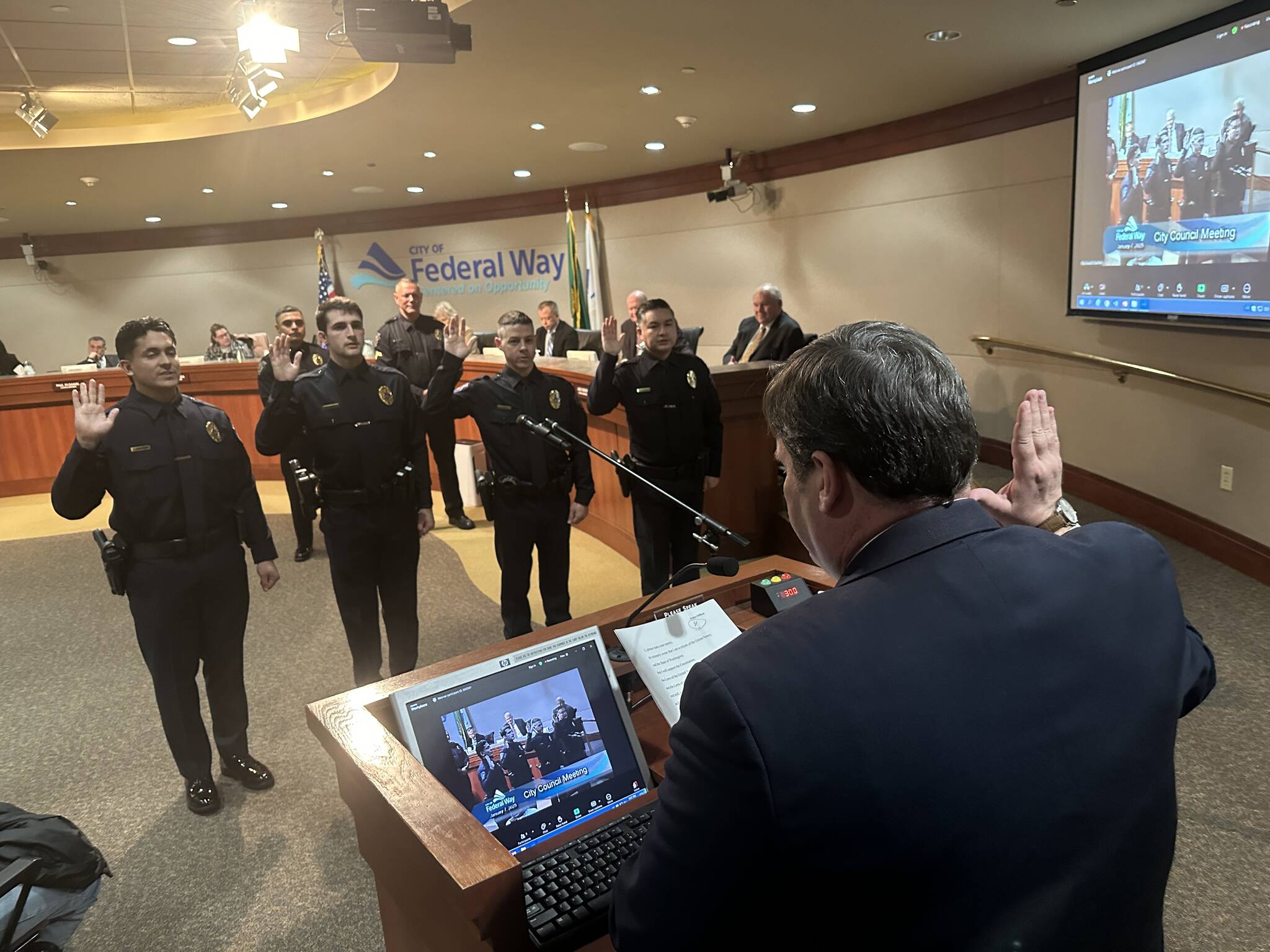 Mayor Jim Ferrell swears in officers of the Federal Way Police Department at the city council meeting on Jan. 7. Photo by Ben Miller.