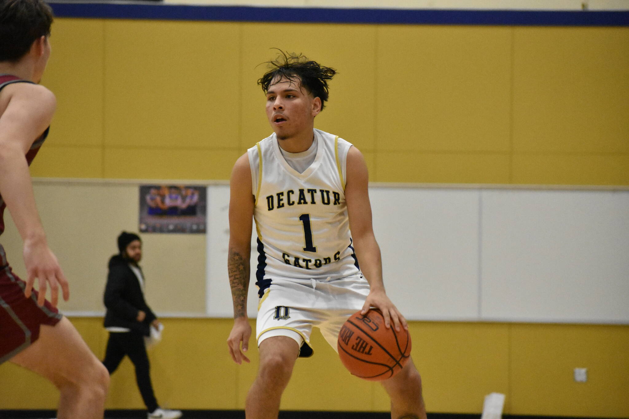 Jorge Martinez Lopez dribbles the basketball for Decatur against Kentlake. Ben Ray / The Mirror